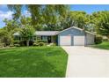 Charming single-story home featuring a two-car garage, well-manicured lawn, and a basketball hoop in the driveway at 1639 Choctaw Trl, Maitland, FL 32751
