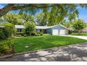 Beautiful single-story home with a two-car garage, landscaped lawn, and a tree-lined street at 1639 Choctaw Trl, Maitland, FL 32751