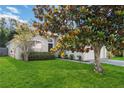Landscaped front yard with a beautiful magnolia tree offers great curb appeal at 16603 Corner Lake Dr, Orlando, FL 32820