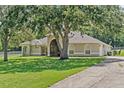 Spacious living area with wood floors and view to breakfast nook at 19630 County Road 455, Clermont, FL 34715