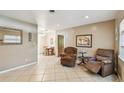 Comfortable living room with neutral tones, tile flooring, and ample space for relaxation at 206 Gerry Dr, Altamonte Springs, FL 32714