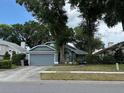 Charming single-story home with a well-maintained lawn, mature trees, and a two-car garage at 2061 Piedmont Park Blvd, Apopka, FL 32703