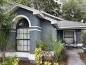 Stylish home showcasing an arched window, decorative columns, and lush landscaping for enhanced curb appeal at 2061 Piedmont Park Blvd, Apopka, FL 32703
