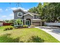 Charming two-story home featuring a spacious three-car garage and a well-manicured front lawn at 207 Via Tuscany Loop, Lake Mary, FL 32746