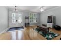 Bright living room featuring a decorative glass-paneled front door, hardwood flooring, and modern fixtures at 207 Via Tuscany Loop, Lake Mary, FL 32746