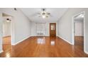 Bright living room with hardwood floors, neutral walls, and decorative wood front door at 241 Ruth Blvd, Longwood, FL 32750