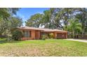 Charming single-story home boasts a well-manicured lawn and mature landscaping at 2678 Wilmhurst Rd, Deland, FL 32720