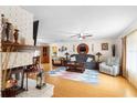 Open-concept living room includes hardwood floors, fireplace, and dining area at 2678 Wilmhurst Rd, Deland, FL 32720