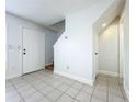Inviting living room area with tile flooring, front door entry and staircase at 3247 Forest Oaks Ct # 116, Winter Park, FL 32792