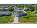 An aerial view shows the home surrounded by a white fence in a peaceful neighborhood at 3256 Amber St, Deltona, FL 32738
