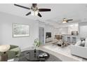 Open-concept living room with modern furniture and a seamless flow into dining area at 3280 Soho St # 306, Orlando, FL 32835