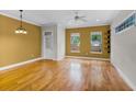 Sunlit living room with hardwood floors, crown molding, and ample natural light at 336 E Kaley St, Orlando, FL 32806