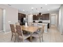 Bright dining area featuring stylish table, seating for six and modern pendant lighting at 3990 Bannock Ave, Tavares, FL 32778