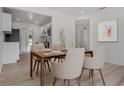 Bright dining room featuring modern decor, wood table set for a meal and wood floor at 4420 Lake Lawne Ave, Orlando, FL 32808