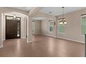 Open entryway featuring tile floors, columns, and a large wooden front door at 480 Buckhorn Dr, Winter Springs, FL 32708