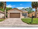 Charming single-story home featuring a two-car garage, solar panels and a beautifully landscaped lawn at 561 Vineyard Way, Poinciana, FL 34759