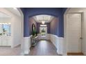 Bright and inviting entryway with stylish decor and a view of the front door at 7206 Nottingham Reel Ct, St Cloud, FL 34773