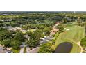 Aerial view of property highlighting golf course, pond, and lush surroundings at 7237 Woodville Cres, Orlando, FL 32819