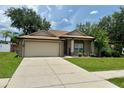Beautiful home featuring lush landscaping and a spacious driveway, perfect for parking at 734 La Costa St, Minneola, FL 34715