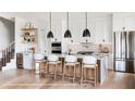 Elegant kitchen featuring a large center island, stainless steel appliances, and modern lighting at 917 Lake Emerald Dr, Orlando, FL 32806