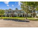 A view of a group of townhomes, featuring landscaping and a well-maintained exterior at 12449 Cruxbury Dr, Windermere, FL 34786