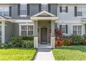 Inviting front entrance features a covered porch, colorful landscaping, and a well-maintained lawn at 12449 Cruxbury Dr, Windermere, FL 34786