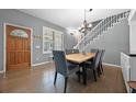 Traditional dining room featuring a wooden table set for six, adjacent to the staircase with natural light at 14202 Nell Dr, Orlando, FL 32832