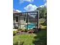 The screened in pool is surrounded by lush landscaping creating a private outdoor oasis for relaxation at 148 Peregrine Ct, Winter Springs, FL 32708