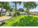 Wide shot of home from lawn, showing garage and neighboring homes at 1511 Center Ave, Holly Hill, FL 32117