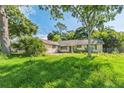 A charming single-story house surrounded by lush greenery and mature trees at 1511 Center Ave, Holly Hill, FL 32117