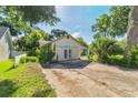 Detached garage with double doors and adjacent concrete parking area at 1511 Center Ave, Holly Hill, FL 32117