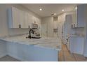 Beautiful kitchen with white cabinets, stone countertops, and a stainless steel microwave at 1679 Shadowmoss Cir, Lake Mary, FL 32746