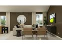 Cozy living room with modern furniture, a round mirror, and a view into the kitchen at 2138 Chris Dr, Winter Haven, FL 33884