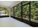 Bright, airy screened porch with views of the lush, green backyard at 216 Homestretch Blvd, Deland, FL 32724