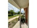 Relaxing porch view overlooking the pond, showcasing outdoor community amenities at 2200 San Vittorino Cir # 102, Kissimmee, FL 34741