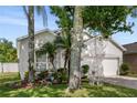 Charming home featuring a two-car garage and lush, landscaped front yard at 253 Clydesdale Cir, Sanford, FL 32773