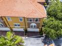 Aerial view of the townhome, with tile roof, garages, and green landscaping at 4244 Messina Dr, Lake Mary, FL 32746