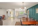 Open-concept dining room flows seamlessly into the kitchen, boasting modern lighting and tile flooring at 5237 Gateway Ave, Orlando, FL 32821