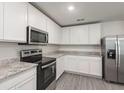 This is a kitchen with granite countertops and stainless steel appliances at 667 Bay Leaf Dr, Kissimmee, FL 34759