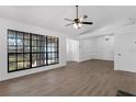 Bright living room with large window, wood floors, and white walls at 762 Lake Como Dr, Lake Mary, FL 32746