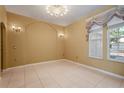 Versatile room featuring neutral colors, tile flooring, and large windows for plenty of natural light at 9128 Phillips Grove Ter, Orlando, FL 32836