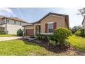 Beautiful home showcasing a well-maintained lawn and colorful landscaping at 922 Suffolk Pl, Davenport, FL 33896