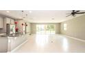 Bright open-concept space with tile flooring and sliding glass doors leading to the backyard at 922 Suffolk Pl, Davenport, FL 33896