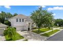 Charming two-story home with a well manicured lawn, mature landscaping, and a two-car attached garage at 10299 Cypress Knee Cir, Orlando, FL 32825