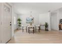 Elegant dining area featuring a modern chandelier, stylish decor, and bright, neutral colors at 1030 Huntington Ct, Longwood, FL 32750