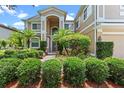 Inviting front entrance with lush landscaping and a well-maintained walkway, adding curb appeal to the property at 1097 Harmony Ln, Clermont, FL 34711