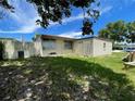 A spacious backyard featuring a weathered fence and lush lawn at 1256 N Pine Hills Rd, Orlando, FL 32808