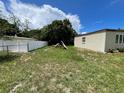 This backyard showcases a white privacy fence and some lawn area at 1256 N Pine Hills Rd, Orlando, FL 32808