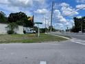 This street view highlights the corner lot and a glimpse of the surrounding neighborhood at 1256 N Pine Hills Rd, Orlando, FL 32808