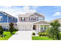 Charming two-story home with a two-car garage, well-maintained landscaping, and inviting front porch at 13993 Title Way, Winter Garden, FL 34787